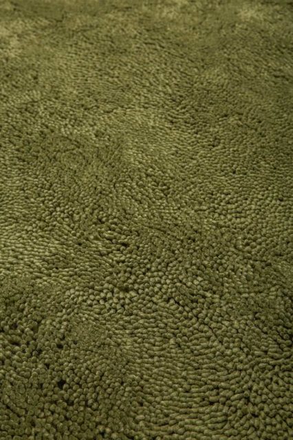 Close up view of textured Napoleon Shag rug in olive green colour